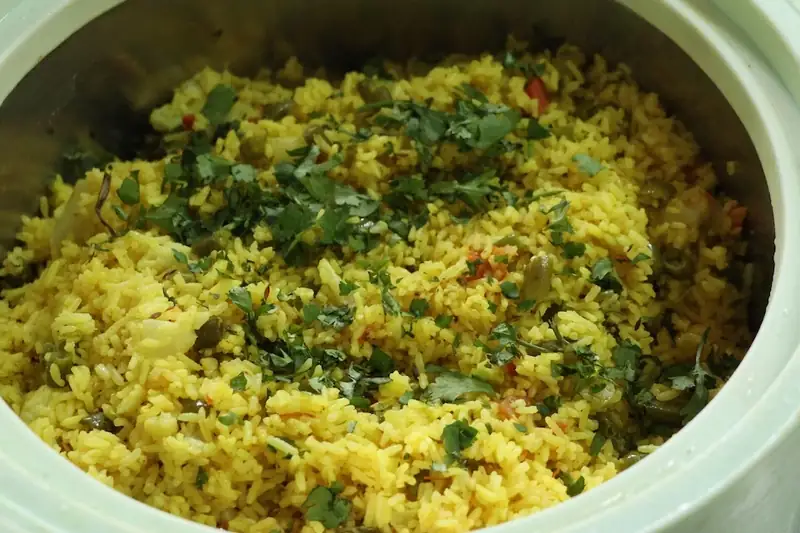 Turmeric vegetable rice with fresh coriander served at Sri Yoga Ashram, Rishikesh