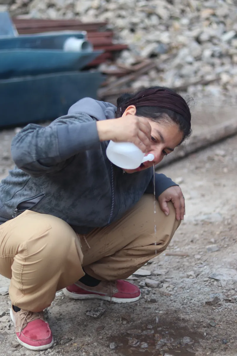 Student practising jala neti nasal cleansing with a neti pot during yoga training in Rishikesh