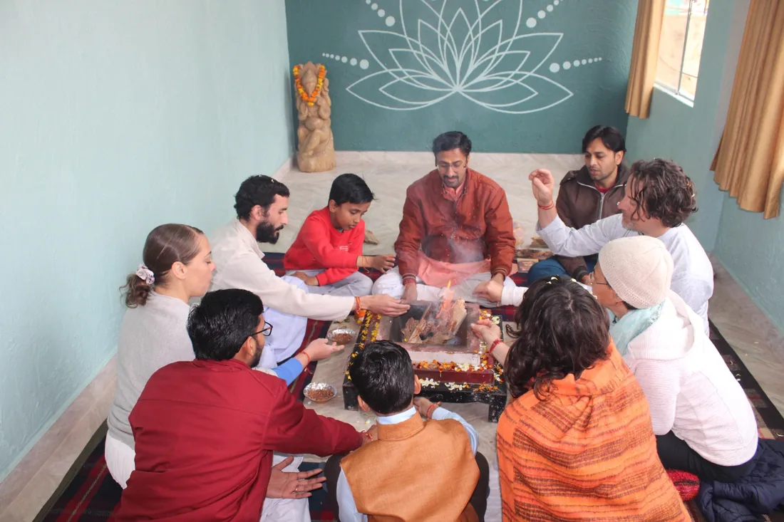 Group seated around the sacred fire during a havan ceremony at Sri Yoga Ashram
